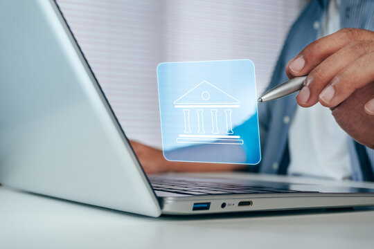 Business professional managing corporate finance with virtual office building interface on laptop for enterprise banking, financial strategy, capital management, corporate investment, business growth