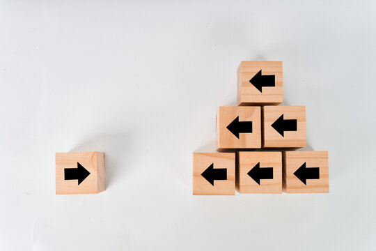 Right arrow cube facing stacked cubes with left arrows isolated on white background
