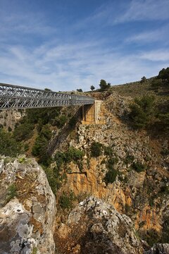 An iron bridge spans a gorge under a blue sky, Aradena Gorge, Aradena, Sfakia, Crete, Greece