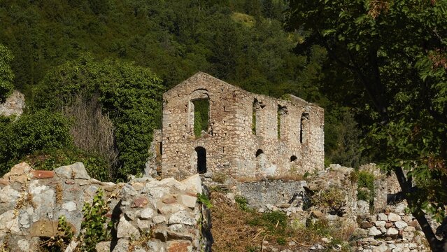 Old, abandoned stone building in the middle of a green forest landscape, Mystras, Mistra, UNESCO World Heritage Site, Medieval Byzantine ruined city, northwest of Sparta, foothills of the Tyagetos Mountains, Peloponnese, peninsula, Greece