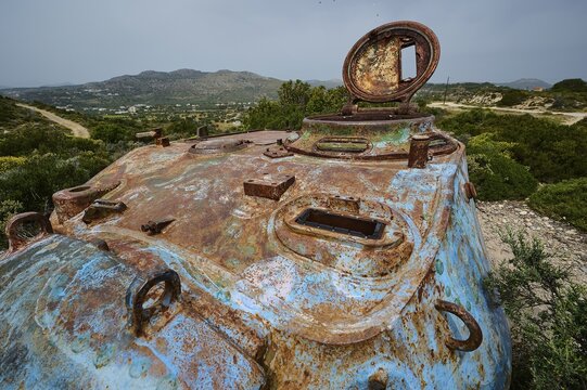 Close-up of a rusty tank with an open hatch in a wide landscape, Anthony Quinn Bay, Vagies Bay, Rhodes, Dodecanese, Greek Islands, Greece