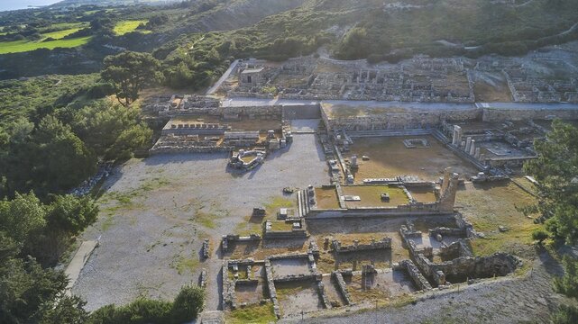 Drone shot, first morning light, Ancient ruins of an archaeological site surrounded by green nature and mountains in daylight, Kamiros, Archaeological site, Ancient city, Foundation of Doric Greeks, Rhodes, Dodecanese, Greek Islands, Greece