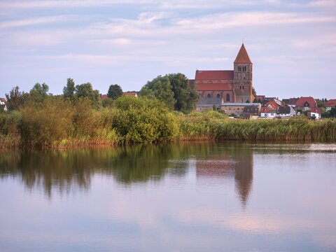 Tribsee with St. Thomas Church in the evening, reflection in a lake, North German brick Gothic, Peenetal River Landscape nature park Park, Mecklenburg-Western Pomerania, Germany