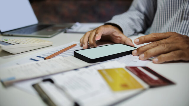close-up shot, man hand using mobile phone to online shopping and paying via credit card, home shopping, online shoping concept