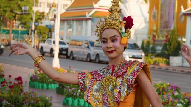 Thai Classical Dancer Performing in Traditional Chut Thai Costume Outdoors