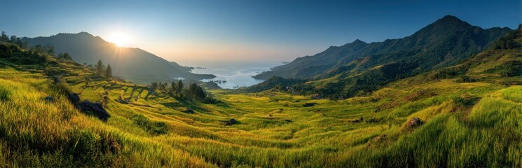 Fototapeta premium Panoramic view of rolling hills mountains and the sea at sunset landscape scenery