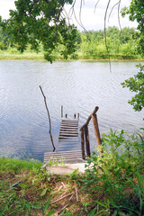 Fototapeta premium Wooden pier on a calm lake shore