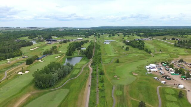 Stunning drone video showcasing TPC Toronto Osprey Valley Golf Course with lush fairways, water features, and manicured greens under bright daylight, captured in smooth, cinematic aerial footage.