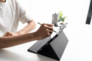 Using stylus on tablet for digital note taking and productivity technology concept. © Charlie's