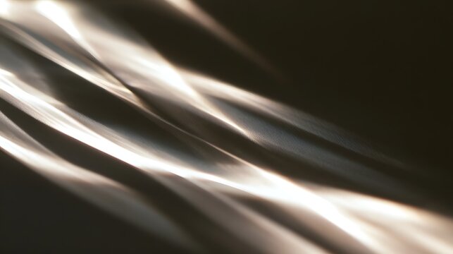 Abstract patterns of light and shadow ripple across a smooth surface  creating soft glowing lines against dark tones