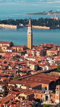 Scenic aerial view of Venice with bell tower and canals revealing historic city architecture.