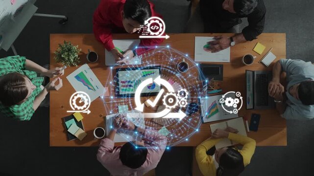 A diverse group of professionals collaborates on a digital transformation project, utilizing visual data and workflow graphics in a modern office setting. Raster