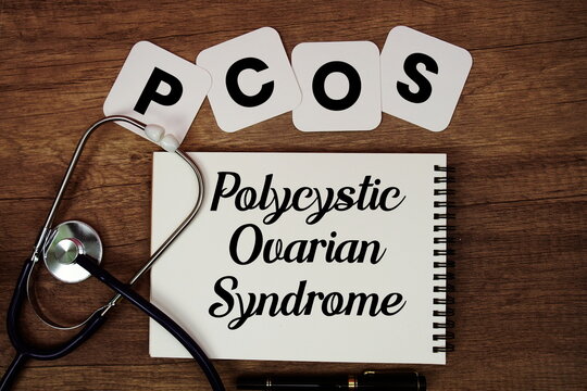 PCOS Polycystic Ovarian Syndrome text written on notepad with stethoscope on wooden background