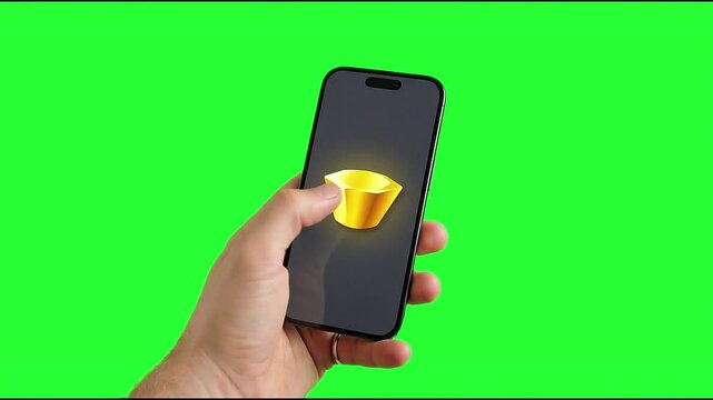 Video, close-up, a hand holding a smartphone displaying a chunk of gold, with an industrial and financial investment backdrop 