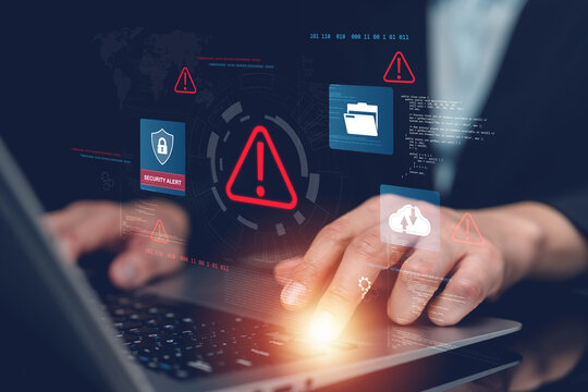 Businessman monitoring cybersecurity alerts on laptop with virtual security interface, threat detection, data protection, cloud security, cyber risk management, malware prevention and network defense