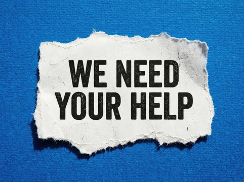 Rough paper with black bold text "WE NEED YOUR HELP," signifying a plea for assistance or support, set against a vibrant blue textured background.