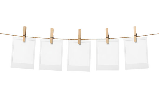 Blank instant frames hanging on clothesline with clothespins, creating a mockup for memories, transparent background