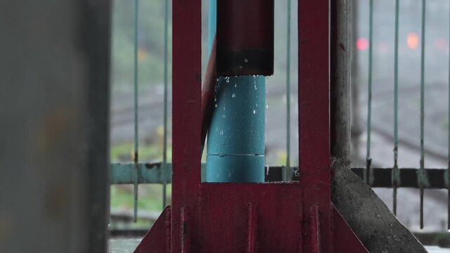 Rainwater is coming out of an iron pipe