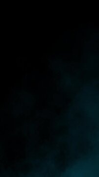 Bank of arctic blue smoke lingers in the lower left corner of the frame. Isolated on black background, ideal for lower third overlays, atmospheric framing, and vfx compositing, vertical format