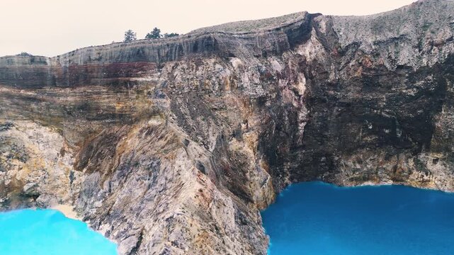 Aerial Horizon Shot Revealing Scale of Indonesian Stratovolcano Crater Lakes. Majestic Mountain Range Landscape with Sulfur Water Pools Under Soft Foggy Sky in Remote Wilderness 4k
