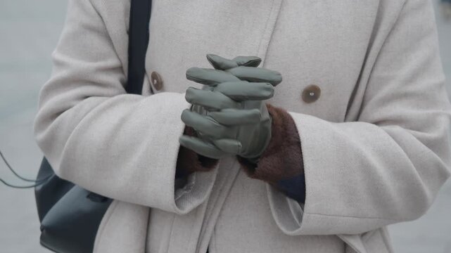 Person wearing a coat and gloves in chilly weather
