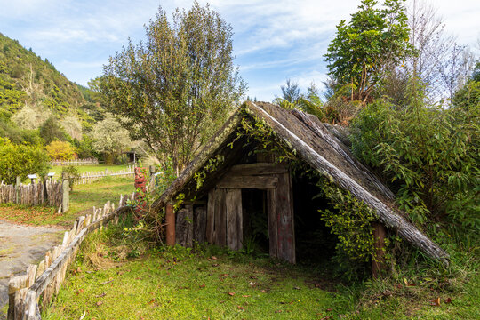 A traditional Maori whare (house) made of tree fern logs on display in Te Wairoa Buried Village, Rotorua, New Zealand