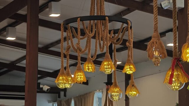 Glowing lamp hanging on the rope.