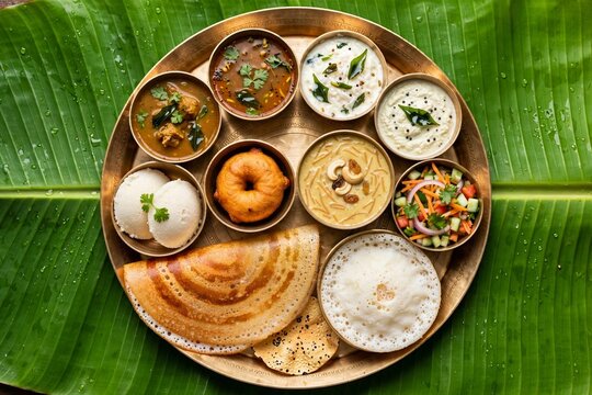 South Indian Vegetarian Thali with Dosa Idli Vada Sambar on Banana Leaf