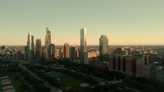 Aerial drone view of the modern Chicago skyline during golden hour. Panoramic cityscape featuring downtown skyscrapers, urban architecture