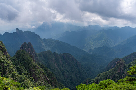 A panoramic view of the majestic green peaks and forested mountains at Sanqingshan Mountain in Jiangxi province of China under a cloudy sky