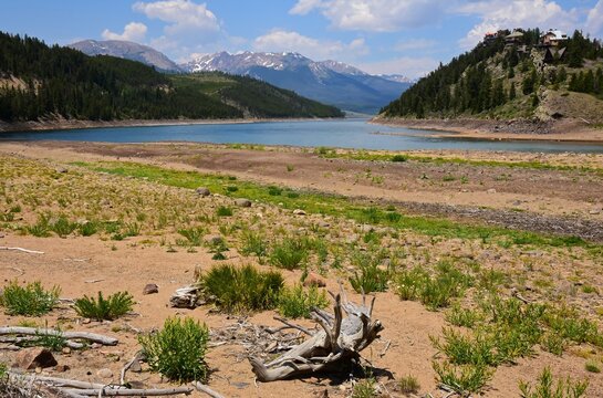 low water levels due to drought at summit cove on the snake river arm of  the dillon reservoir on a sunny summer day, looking out at the rocky mountains in dillon, colorado