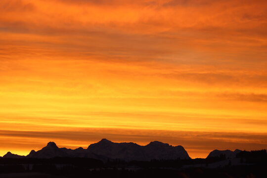 Dramatic Sunset Sky Over Silhouetted Mountains