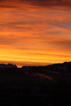 Fiery Sunset Over Hill Silhouettes