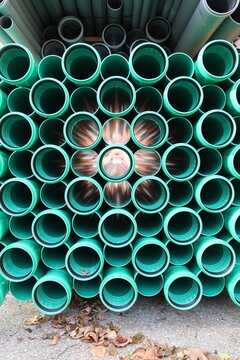Stack of Green PVC Pipes