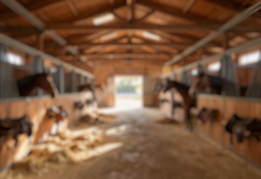 Defocused horse barn interior with wooden stalls, ideal for ranch, farming, and livestock themed backgrounds.