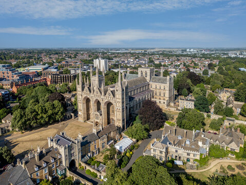 Peterborough Cathedral and Peterborough city centre, Cambridgeshire, England, aerial view showcasing the historic medieval cathedral surrounded by the modern city and urban landscape.