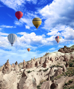Balloon flight, famous tourist attraction of Cappadocia. Air balloons and Fairy Chimney in Pasabag Valley, Anatolia, Turkey. Topic of vacation, travel, trip abroad on vacation, cruises and tours
