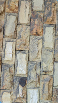 Close up of exterior wall with rectangular rough hewn stone tiles