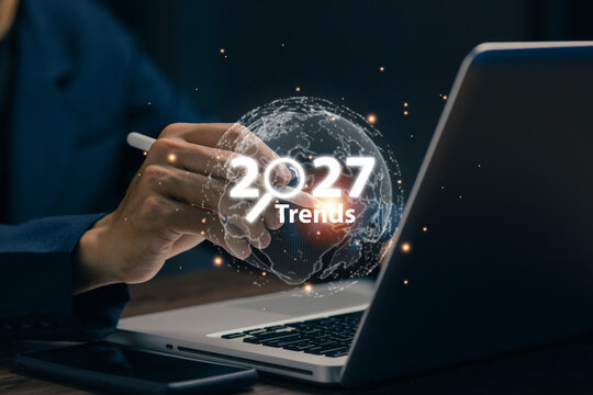 Business professional analyzing global trends for 2027 with digital globe visualization, representing market insights, innovation, technology, strategic planning and worldwide business transformation.