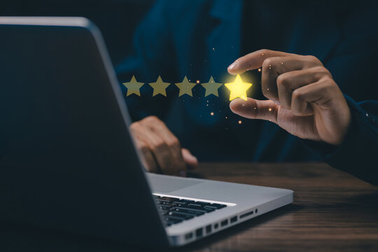 Customer satisfaction concept with glowing five-star rating above a laptop, symbolizing positive reviews, service excellence, user experience, quality evaluation, trust, and business reputation.