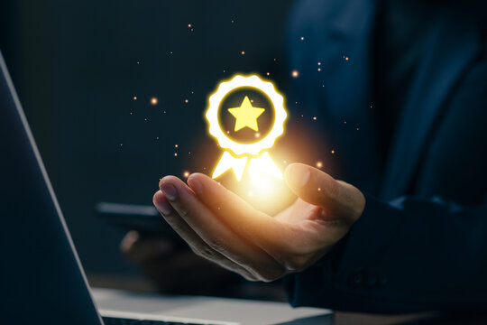 Glowing quality certification badge floating above a business professional's hand, representing excellence, trusted standards, customer satisfaction, business achievement, recognition.