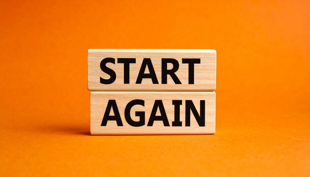 Stacked wooden blocks with start again text on orange background.