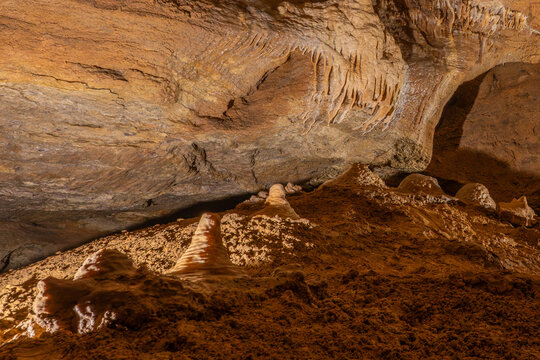 Natural limestone cave wall with mineral formations and detailed rock textures stalactite limestone