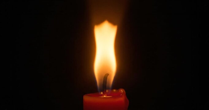 Candle flame looped animation. Glowing candlelight motion effect isolated on black