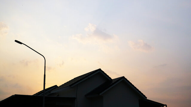 Residential House Silhouette Against Warm Evening Sky