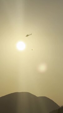 Helicopter battling wildfire smoke