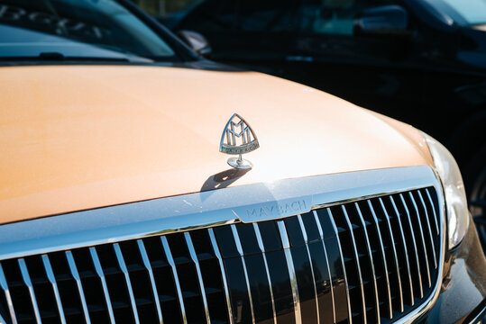 A luxury vehicle maybach with a distinct brand logo is parked in a busy urban area. Smolensk, Russia 07.17.2026