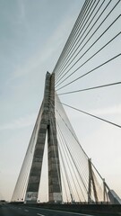 Naklejka premium Modern Cable-Stayed Bridge with Tall Support Tower and Steel Cables