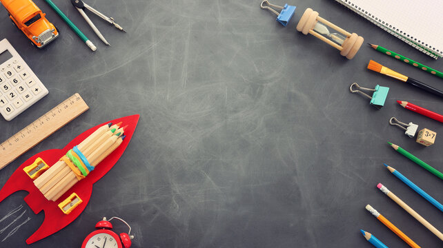 Back to school concept over classroom blackboard. Top view