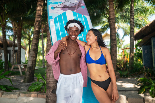Active summer lifestyle with beach sports, fitness romance. Happy couple enjoying paddle boarding